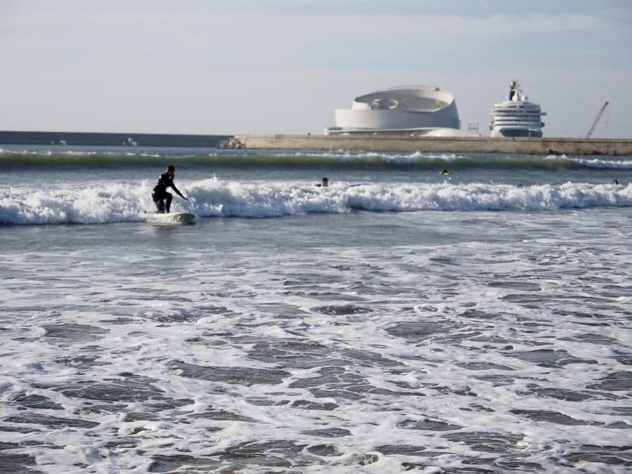 A surfer riding a wave off Matosinhos beach
